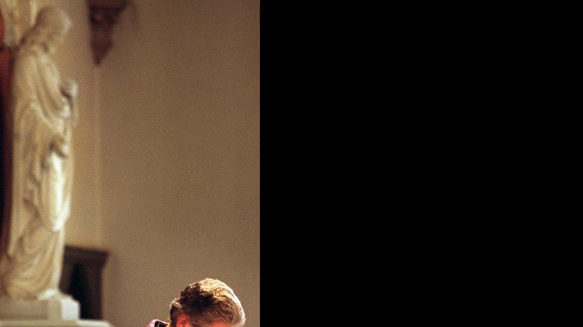 
The Rev. Seamus Laverty, pastor of Saint Patrick Catholic Church in Tacoma, prays for a very quick resolution to the war in Iraq and a lasting peace during Mass Sunday, March 23, 2003. Laverty retired from the priesthood at the end of June.
