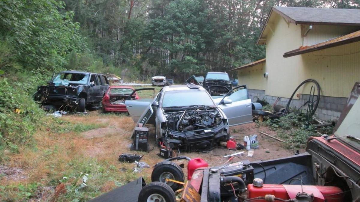 Vehicles and other items litter this property on Chapman Drive NW in Gig Harbor which police say was being used as a chop shop.