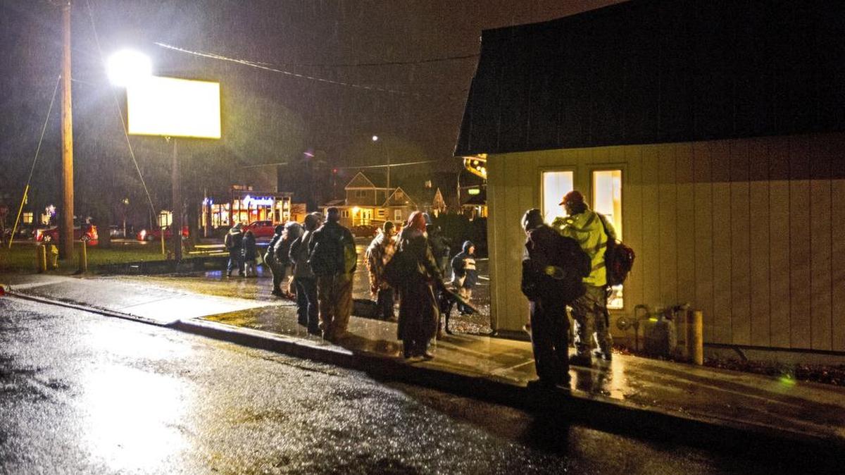 Homeless people wait for New Hope Resource Center in downtown Puyallup to open at 5:30 p.m. as part of its Freezing Night Program, Din December. At 7 p.m. they will be taken to churches that volunteer sleeping space for the night. The city has imposed new rules on the center, designating it as high impact.
