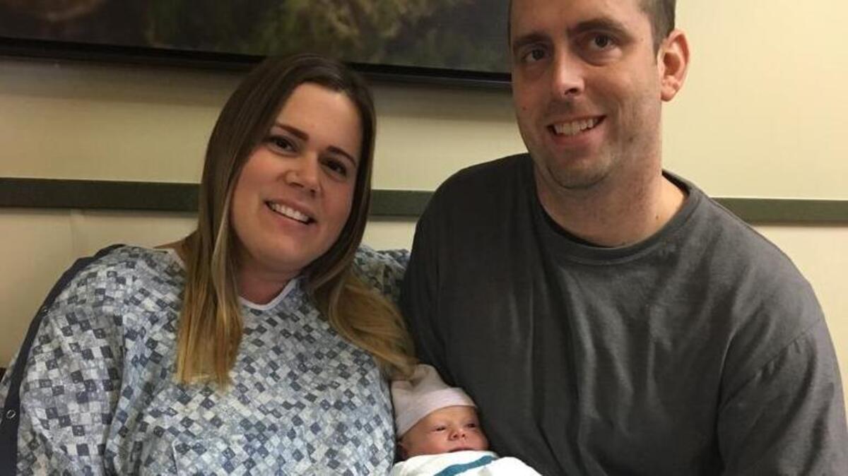 Tacoma’s first baby of 2018 poses with parents Stacey and Derek Hansen.