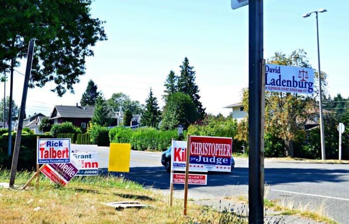 Campaign signs are not supposed to be placed in such a way as to create a traffic hazard or block visibility. These at North 30th Street and Union Avenue in Tacoma seem to be straddling the line. Can you find the oncoming car?