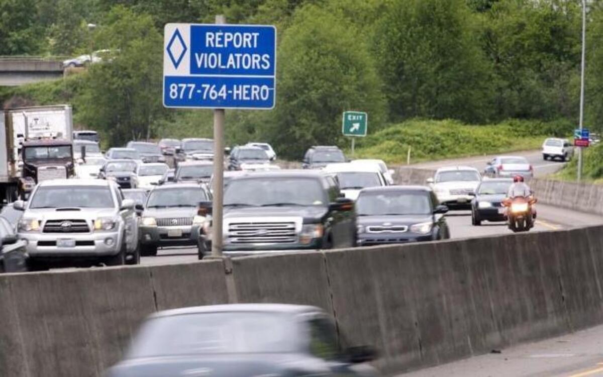 A Washington Department of Transportation sign on northbound state Route 167 in Kent, shown Thursday, encourages drivers to report HOV lane violators.
