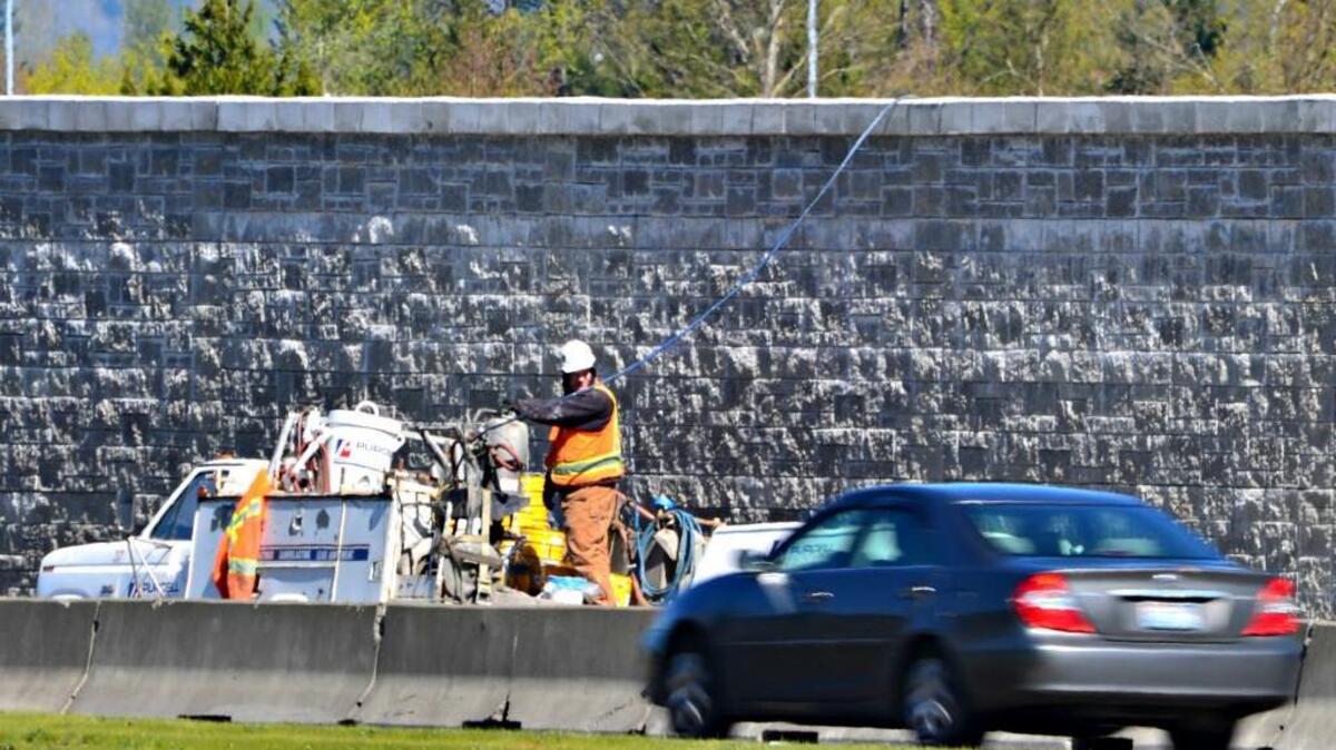 A new noise wall along state Route 167 between Algona and Auburn is built of concrete blocks instead of the usual 12-foot pre-cast panels.