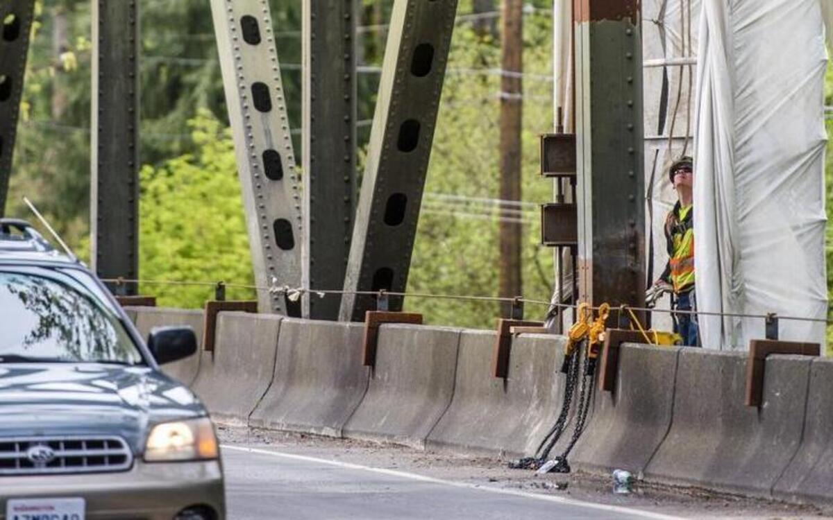A construction worker looks April 13 at the heavy steel beams that were later replaced and reattached on the state Route 410 bridge over the White River between Buckley and Enumclaw. The weeklong planned bridge closure will reopen three days early.
