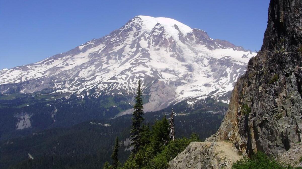 Mount Rainier fills the horizon for hikers on the return trip from Pinnacle Saddle. The saddle is a short hike from Stevens Canyon Road.