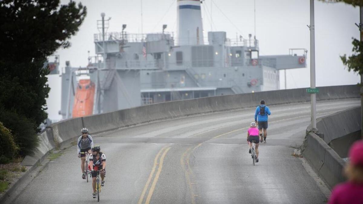 Bicycle riders take advantage of a closed Ruston Way overpass during the 2014 Downtown to Defiance event. It’s happening again Sunday.