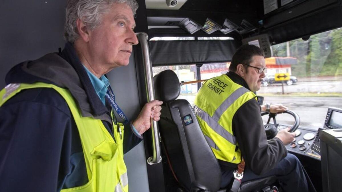 Bus safety and training instructor Mark Veach, left, works with Rob Allen, 52, in February. Pierce Transit is seeking relief transit operators who cover for full-time operators who take time off because of illness or vacation.