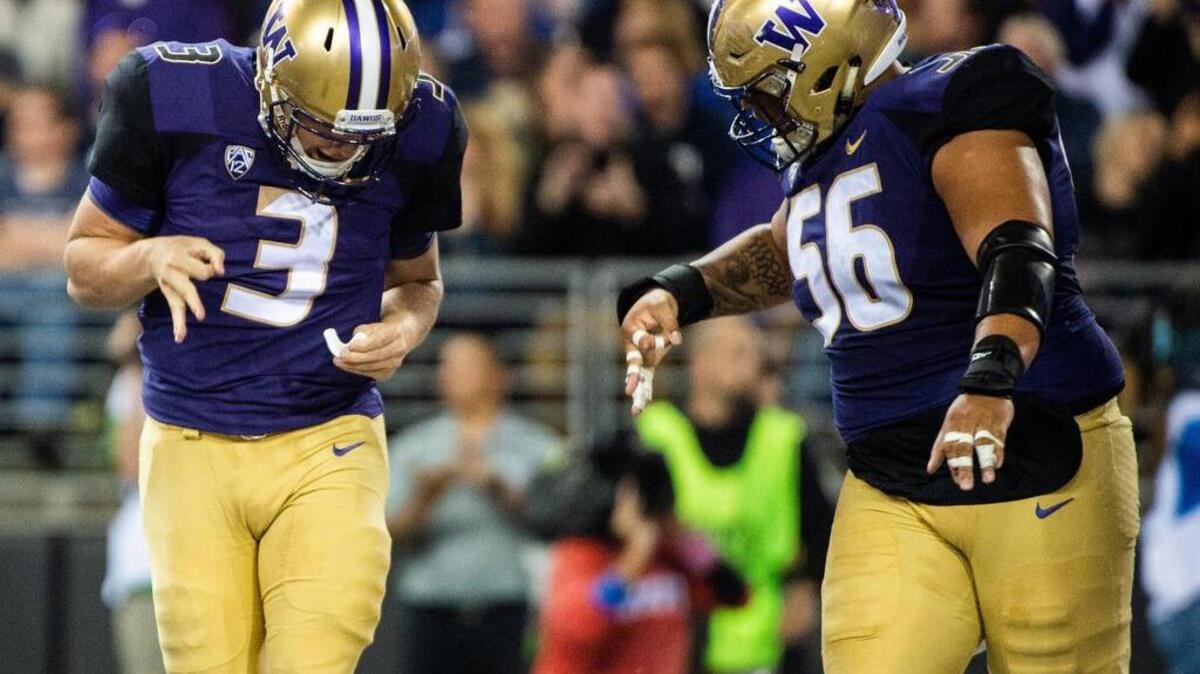 Washington quarterback Jake Browning and Washington offensive lineman Nick Harris celebrate Browning’s rushing touchdown in the second quarter. The University of Washington Huskies played Brigham Young University in a NCAA football game at Husky Stadium in Seattle, Wash., on Saturday, Sept. 29, 2018.