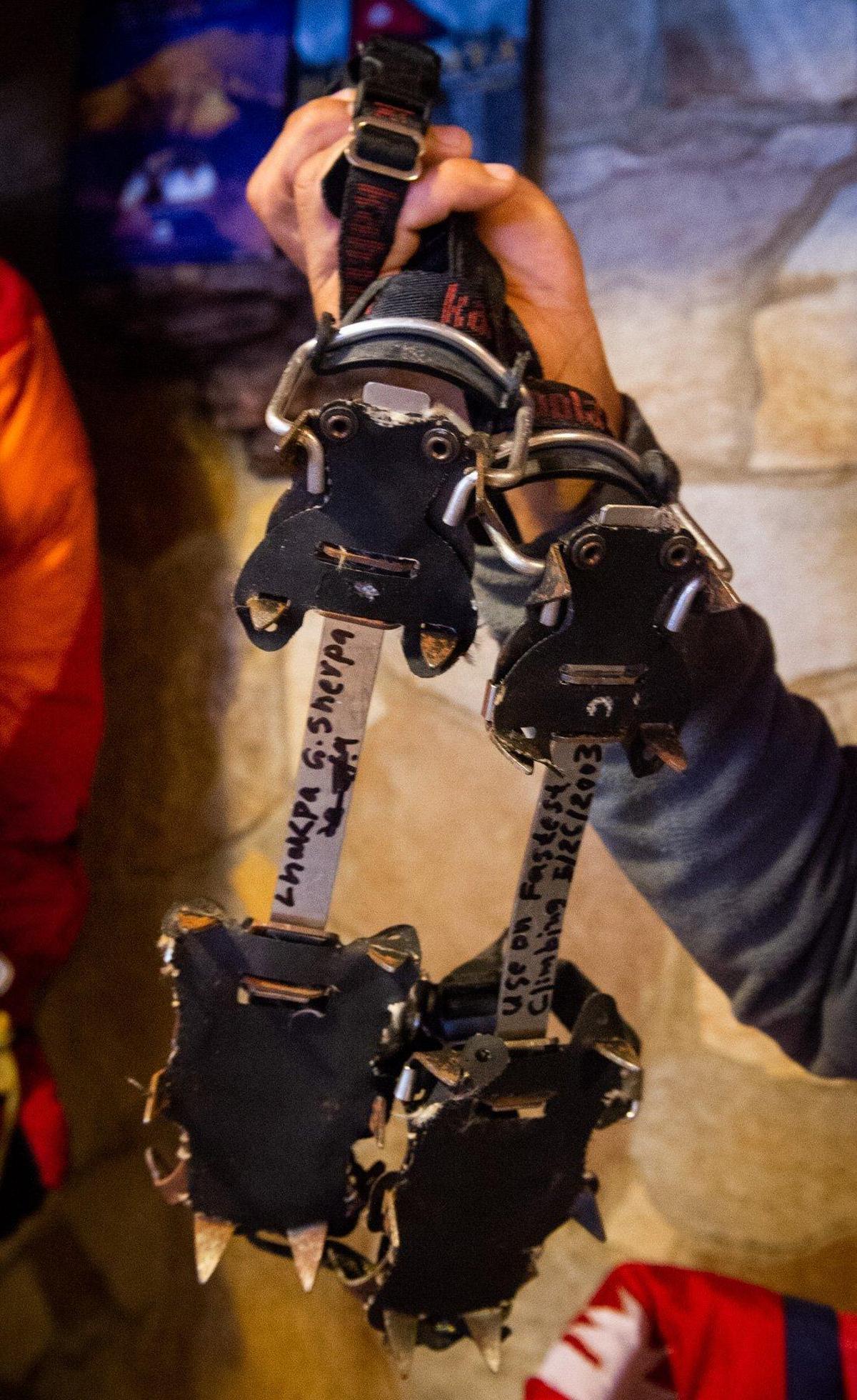 Lhakpa Gelu Sherpa holds the crampons he wore during the fastest ascent of Everest. Photographed at his restaurant, Wildberry Restaurant, in Ashford, Wash., on Thursday, June 20, 2019.
