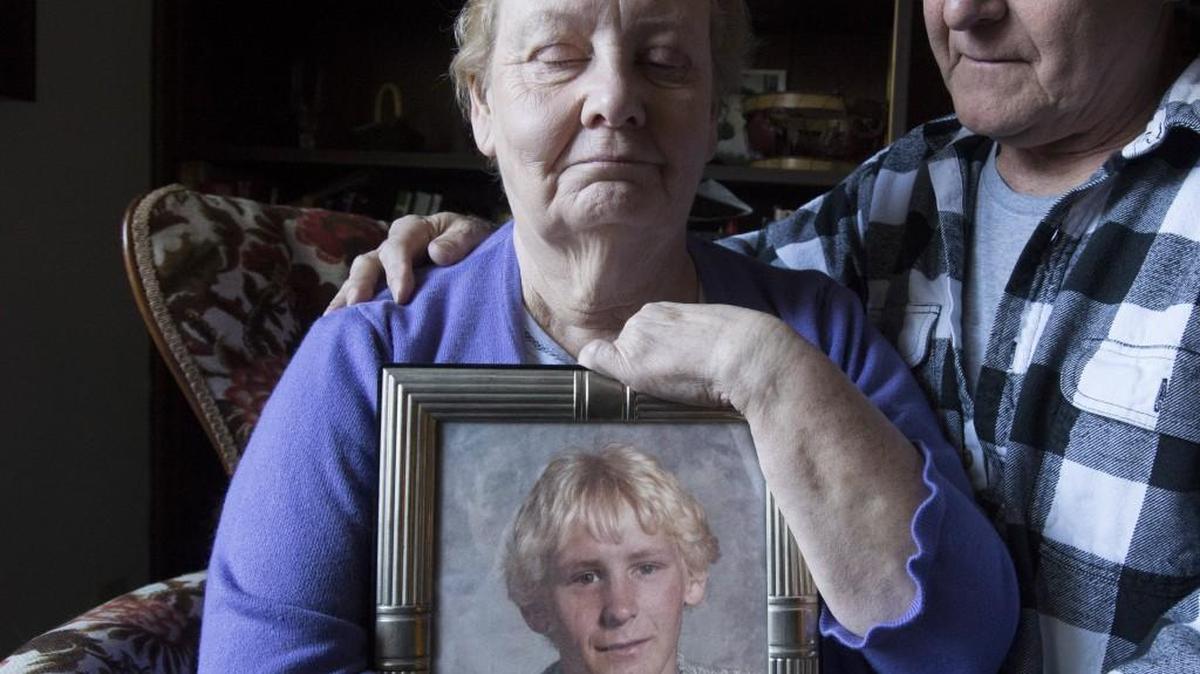 Nona Smith holds a picture of her son Matthew while husband Ben lends support at their Bonney Lake home in March. Matthew died in October while at the Pierce County Jail. He had severe Crohn’s disease and needed medical attention that he wasn’t given, the parents contend in a suit.
