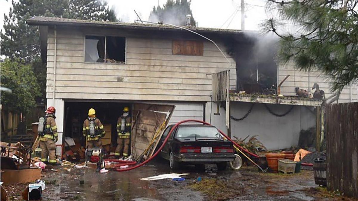 Firefighters knock down a blaze early Wednesday at a vacant home in the 6300 block of North Hale Street in Tacoma. The building sustained heavy damage.