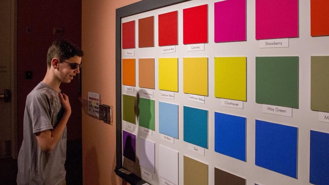Eli Robinson, 13, enjoys seeing stark differences in colors for the first time Friday as he looks around a gallery at the Museum of Glass in Tacoma. The colorblind teen is wearing newly developed glasses that counter a common form of colorblindness.