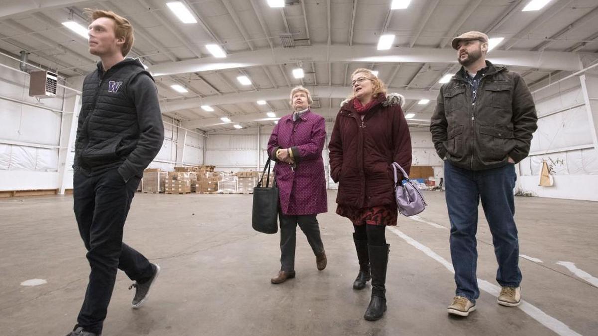 Youth commissioner Hunter Orcutt, from left, volunteer Shirley Binkley, Lacey Museum director Erin Quinn Valcho and Lacey Historical Commission chair Erich Ebel walk through the empty building that will house the new Lacey History Museum.