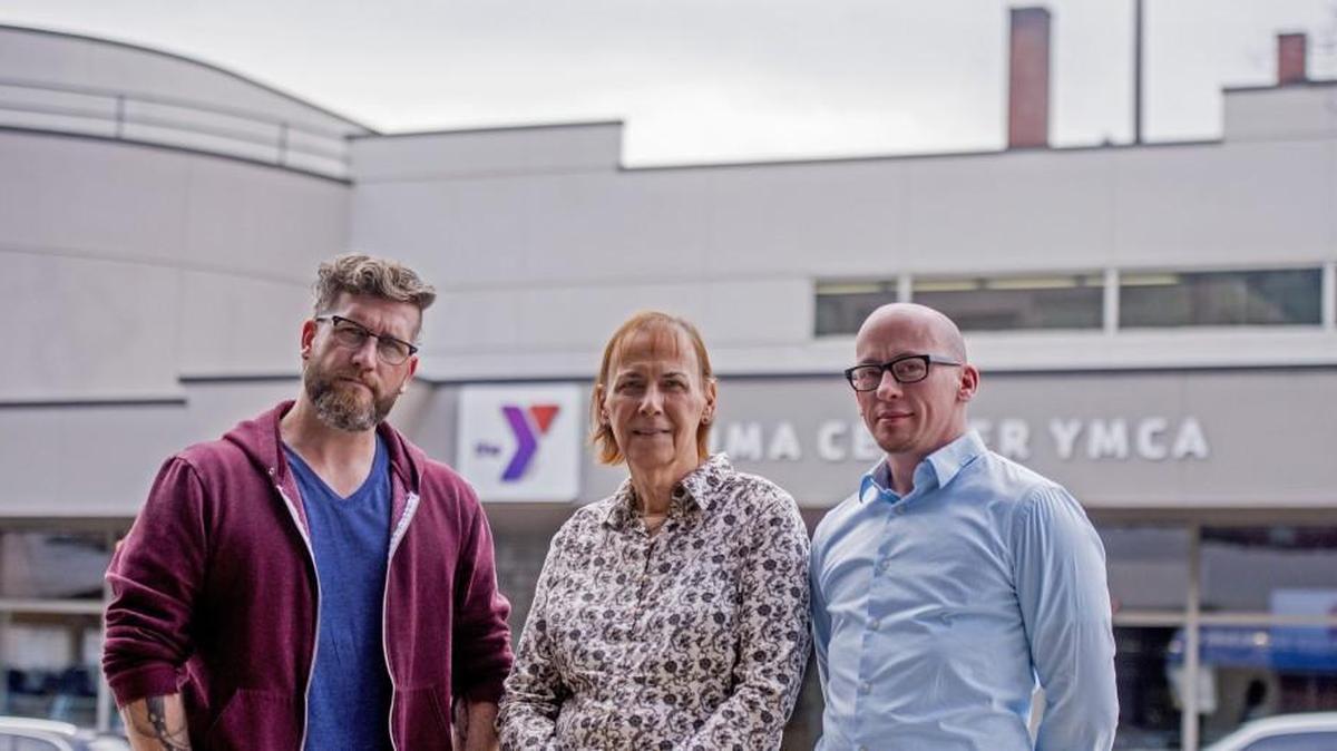 
Aaron Stevens, left, Fran Norman and Seth Kirby stand in front of the downtown YMCA on Thursday. They are unhappy with the Y’s policy on transgender people. Stevens is father to a transgender son, Norman is transgender, and Kirby is the director of the Oasis Youth Center.
