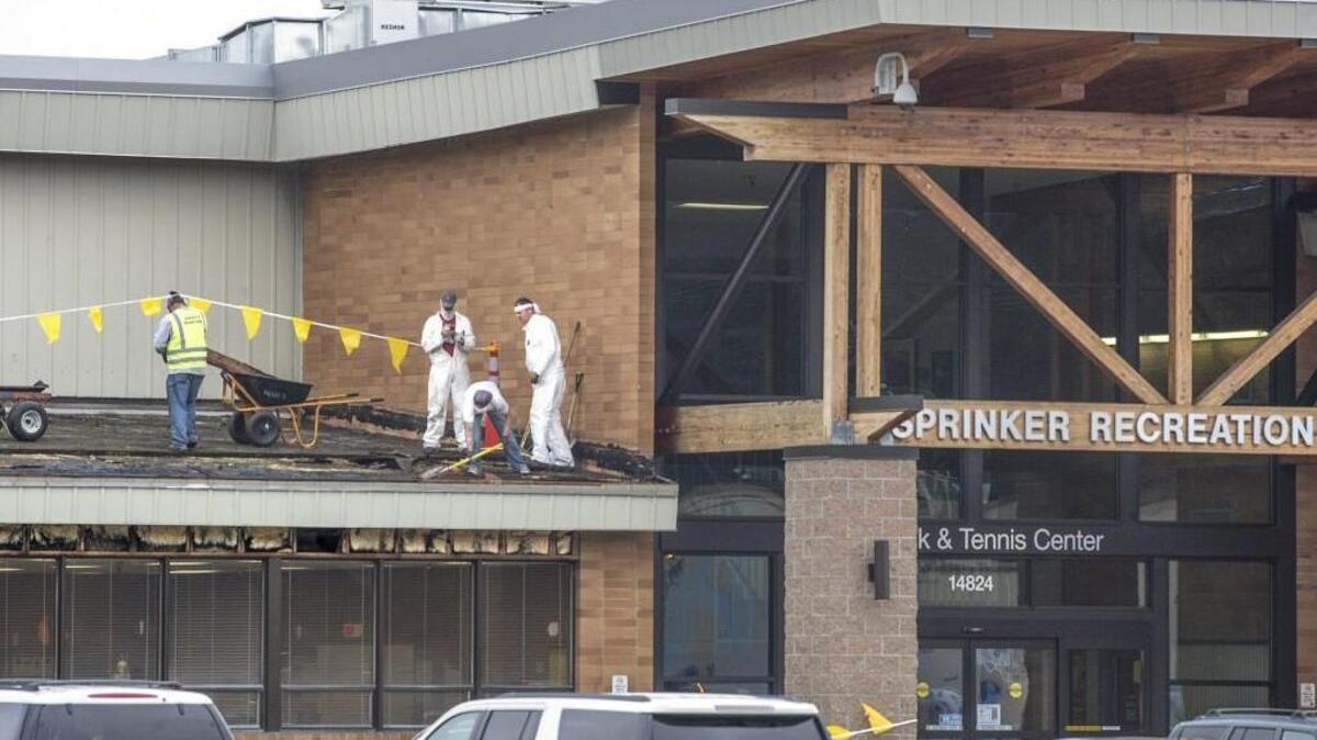 Roofers strip old roofing material and sheathing from the front area of the the Sprinker Recreation Center Wednesday morning. Five years after Pierce County rebuilt the failing roof at the Sprinker Recreation Center’s ice rink, it is redoing the roof on the rest of the 40-year-old Sprinker Recreation Center building. The new roof will cover Sprinker’s racketball courts and classrooms.