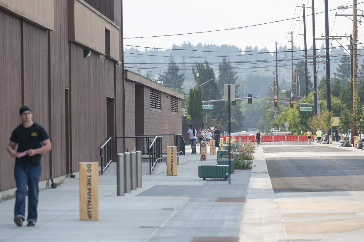 People walk along 9th Avenue Southwest on Thursday, Sept. 4, 2025, outside of the Washington State Fair Event Center in Puyallup, Wash.