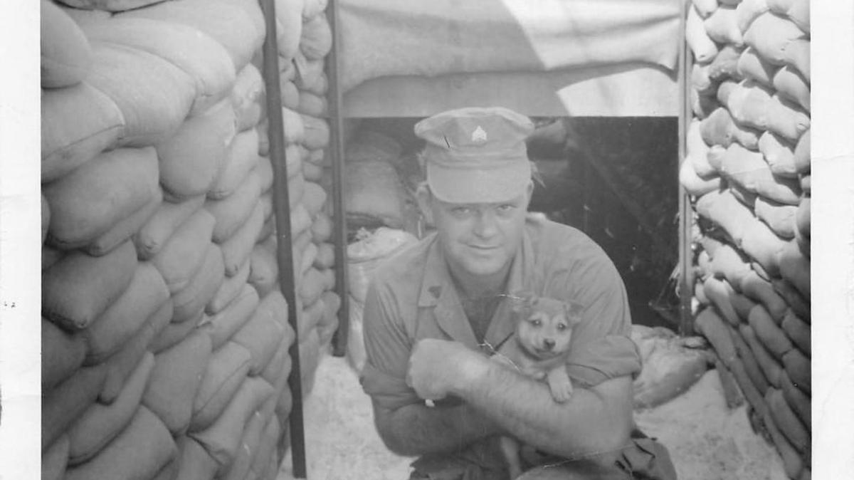 James Beck holds a puppy while serving with the U.S. Army in Vietnam in the late 1960s.
