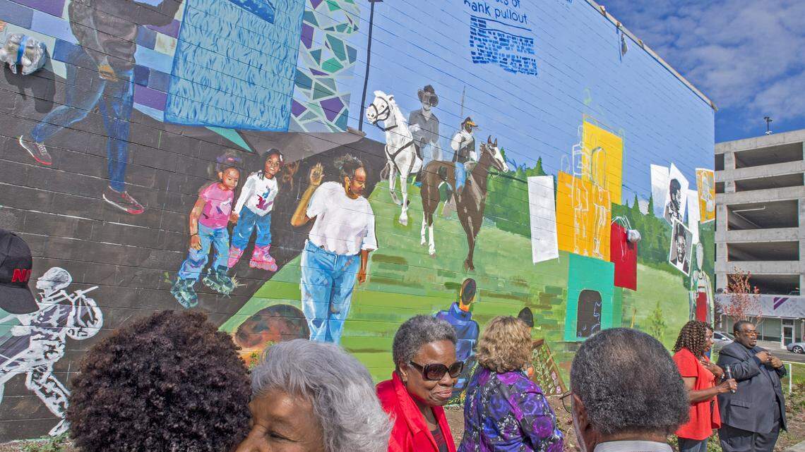 Harriet Williams shares the love after talking about the history of People's Community Center as the partially-completed mural is introduced during the grand opening of the new pool, September 24, 2016. In November, Tacoma voters will be asked to increase the city's sales tax to fund arts-and-culture programs.