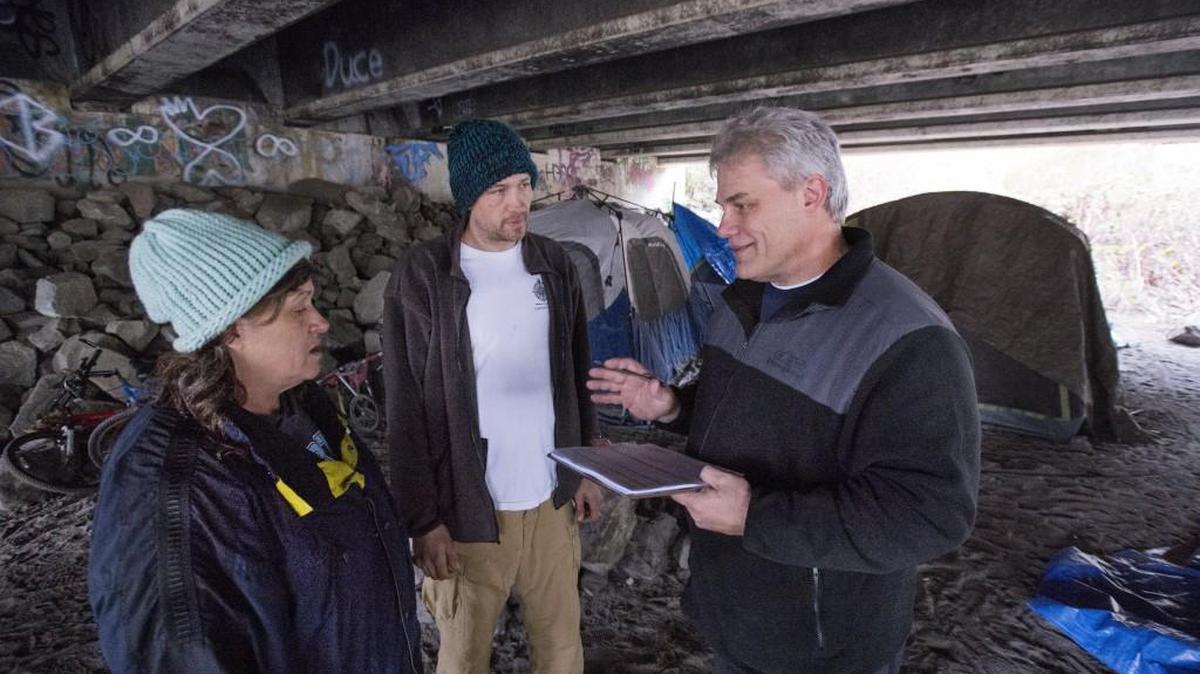 Volunteer Darin Borden, right, surveys Shaun Van Allen and Tina Moynihan during the annual Point-in-Time (PIT) count of sheltered and unsheltered homeless persons in Pierce County on Jan. 29, 2016.