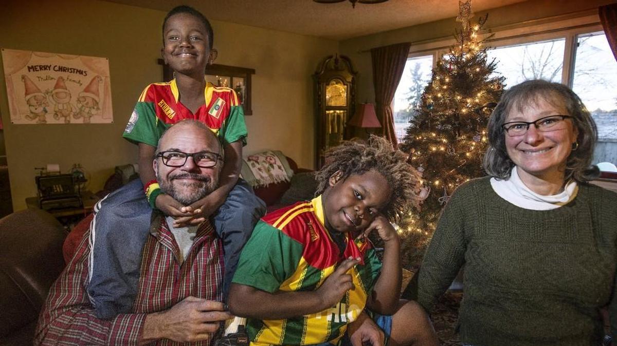 Local teacher Andrew Milton, left, and his family — wife Sandy and son Peter, 9, center, are back from a trip to Ethiopia, where they adopted 9-year-old Eliyas, left. The boys are wearing soccer jerseys in the colors of the Ethiopian flag.
