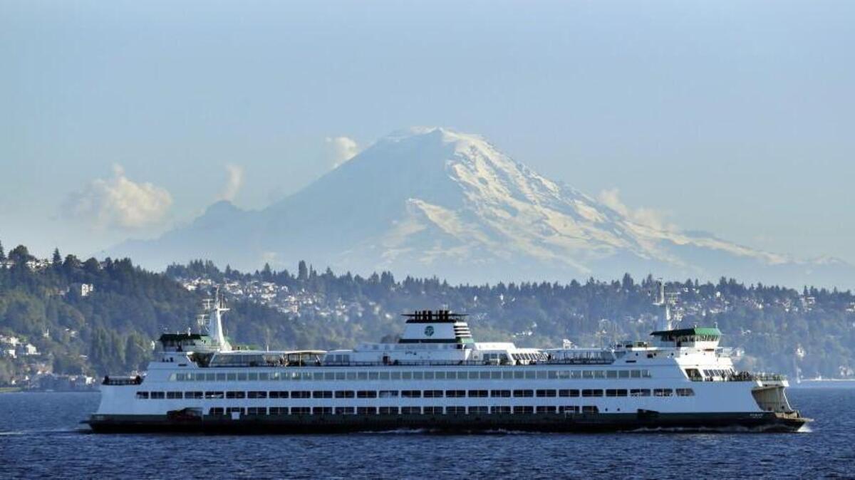 A Washington state ferry passes in front of Mount Rainier near Seattle.