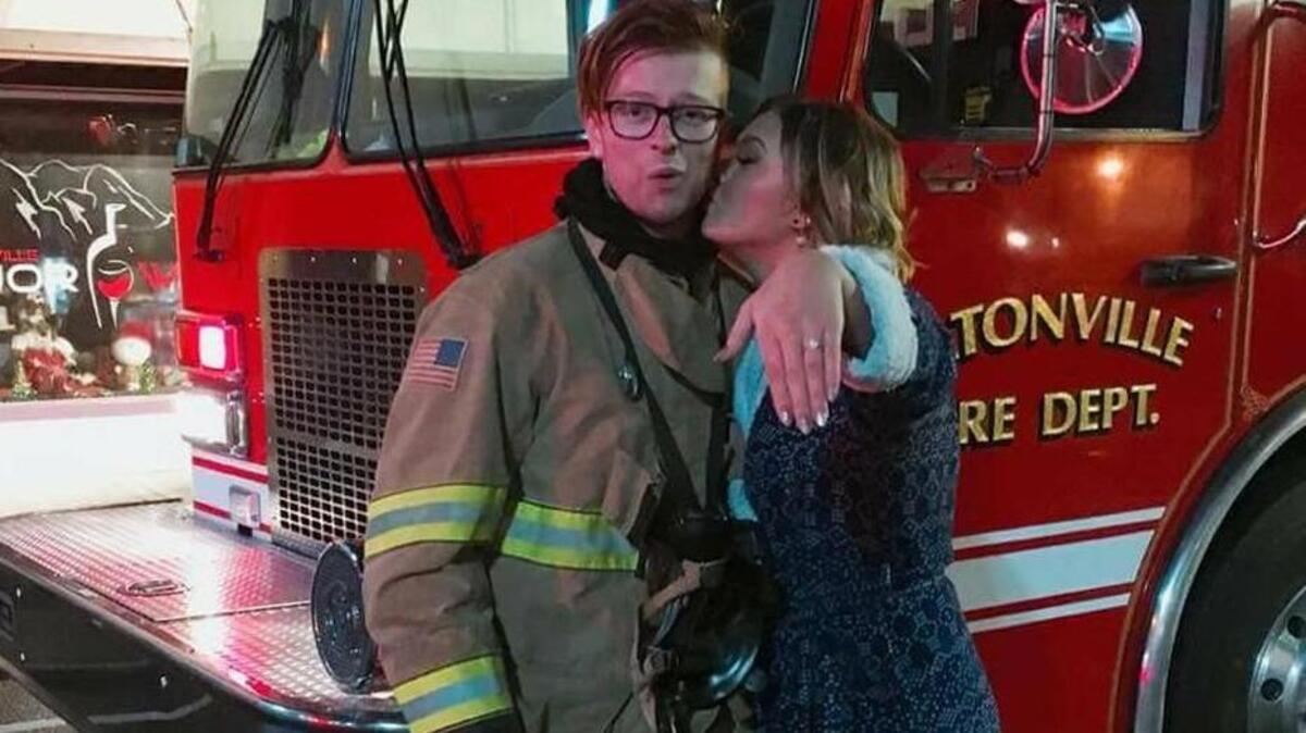 Pierce County firefighter Lucas Mayne and fiancé Summer Holst outside the scene of a fire Dec. 3, 2017 in Eatonville.