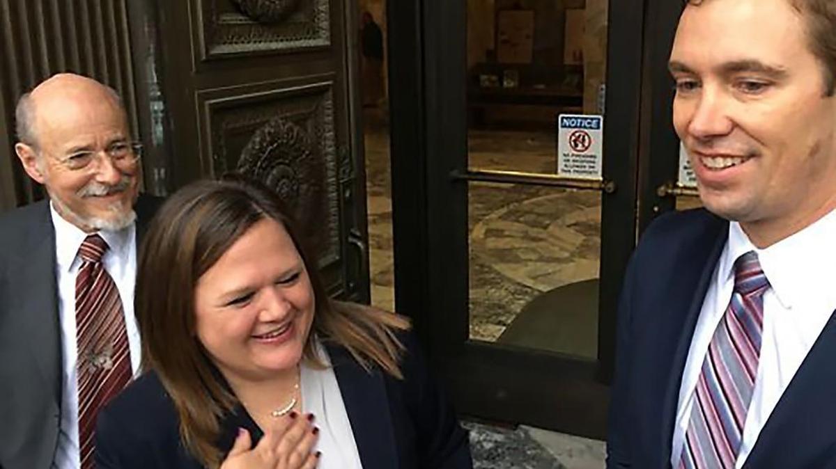 Tarra Simmons, center, with her attorneys, John Strait, left, and Shon Hopwood.