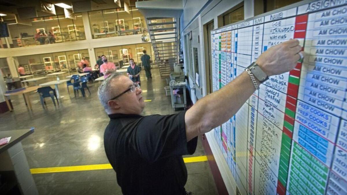 
Corrections deputy Chris Erwin manages the jail trustees scheduling board at the Pierce County Jail in November 2014. The Pierce County jail is trying to hire 22 more deputies this year after laying off 16 deputies in 2013.
