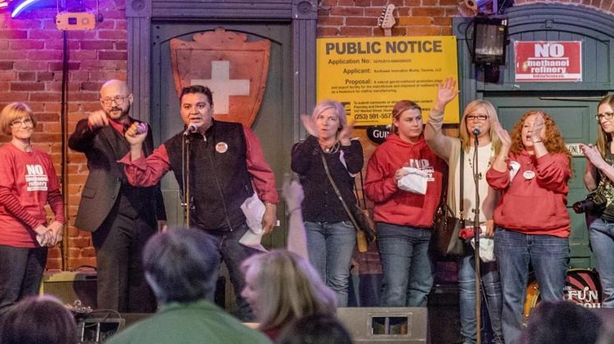 Principal activists with the group formerly known as RedLine Tacoma gather on stage during a victory celebration at The Swiss, April 24, 2016. The group, whose efforts helped to scuttle plans to build a methanol plant on the Tideflats, recently changed its name to Redefine Tacoma.