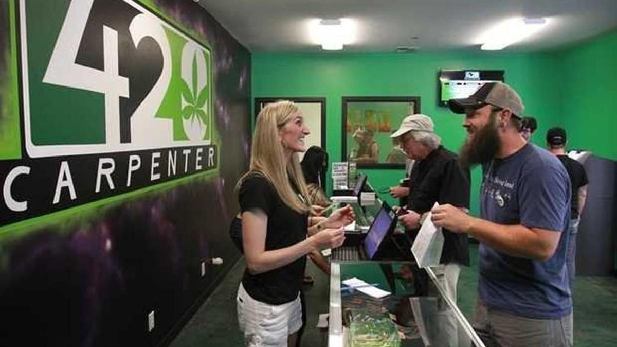 A customer smiles as he completes his purchase during the first day of recreational marijuana sales in Thurston County at 420 Carpenter east of Lacey on July 11, 2014. Washington state Attorney General Bob Ferguson said he is prepared to “defend the will of Washington voters,” amid talk of “greater enforcement” of federal marijuana law nationwide at Thursday’s White House news briefing.