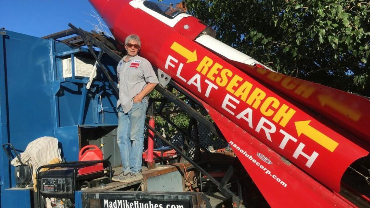 In this Wednesday, Nov. 15, 2017, photograph, daredevil/limousine driver Mad Mike Hughes is shown with with his steam=powered rocket constructed out of salvage parts on a five-acre property that he leases in Apple Valley, Cal. Hughes plans to launch his homemade contraption on Saturday near the ghost town of Amboy, Cal., at a speed of roughly 500 miles-per-hour.