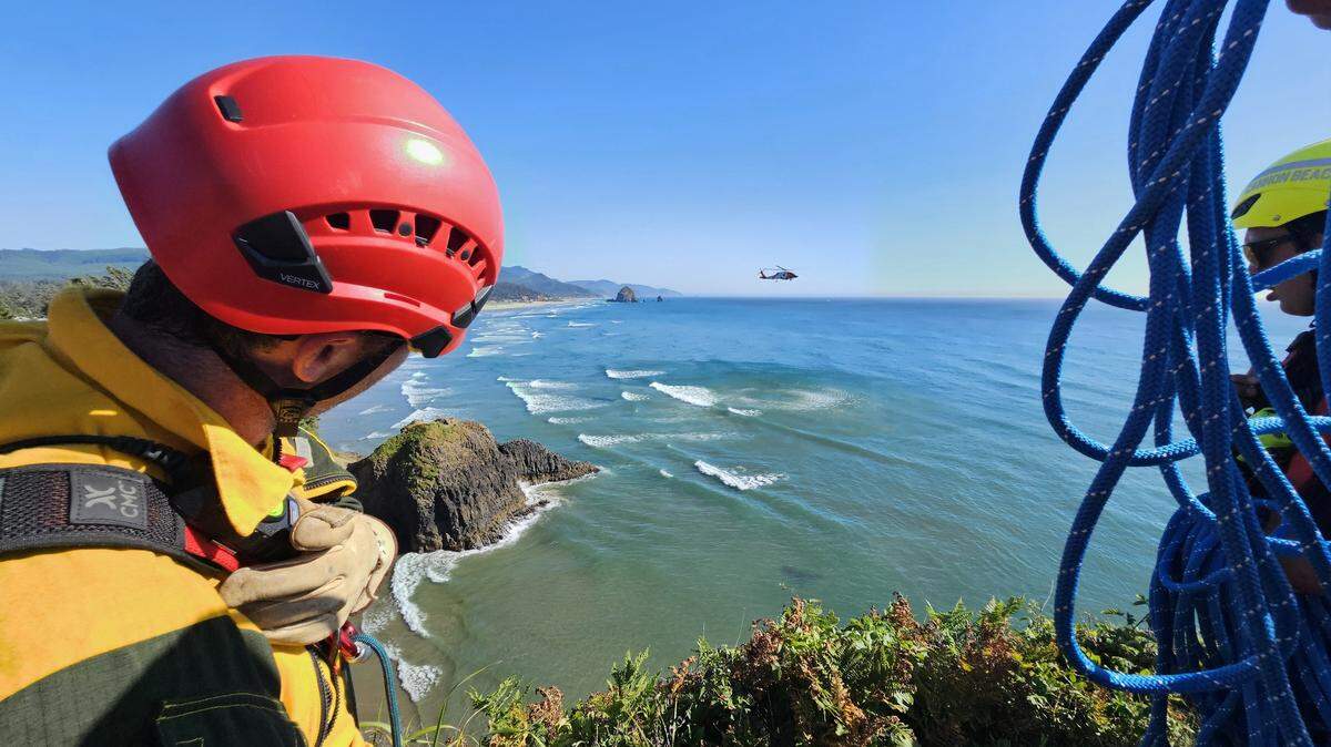 Multiple agencies, including the U.S. Coast Guard, helped rescue two teens stuck on a cliff in Cannon Beach, Oregon, fire officials said.