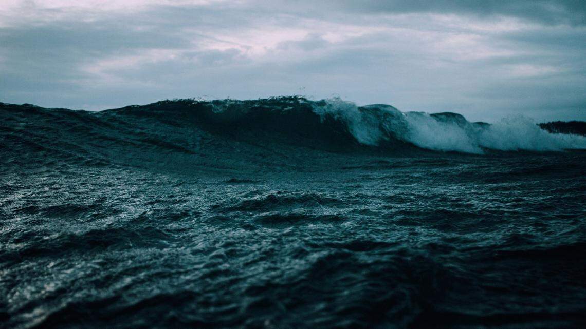 File photo of dark ocean waves. Rescuers found a missing man on a boogie board in the water off an Oregon beach.