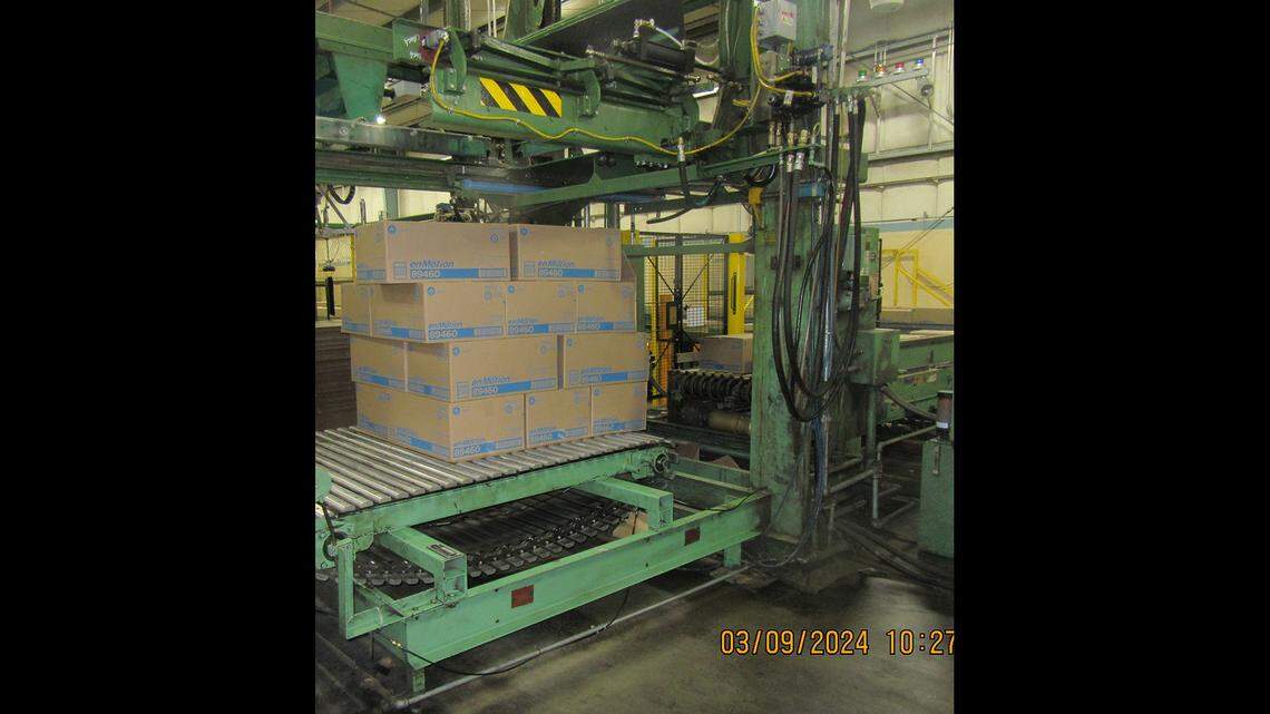 A packing machine is pictured. The metal arms came down and crushed a 32-year-old worker, officials said.