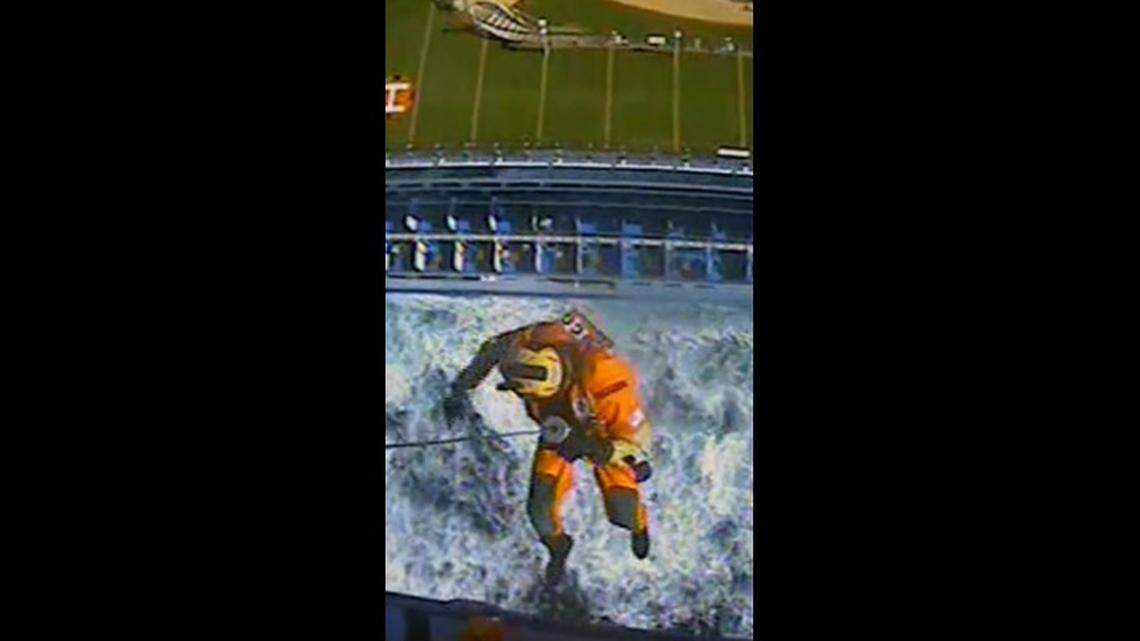 A U.S. Coast Guard helicopter lowers a rescuer to the Ruby Princess cruise ship 145 miles off the coast of Washington.