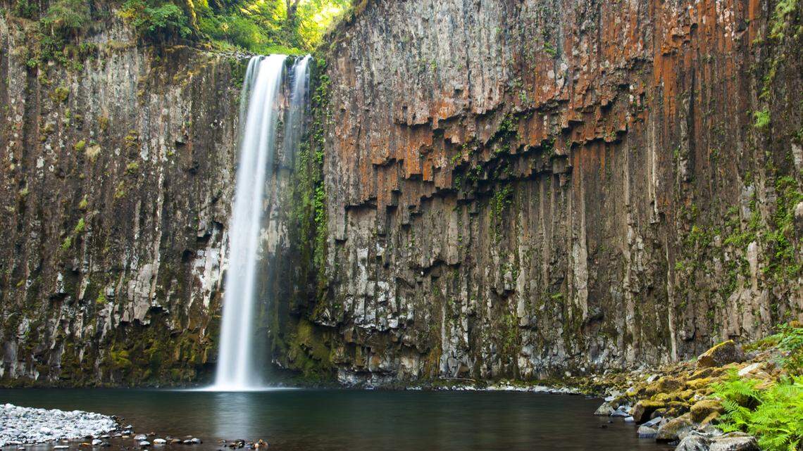 Abiqua Falls in Oregon is pictured. The 92-foot waterfall is surrounded by basalt rocks.