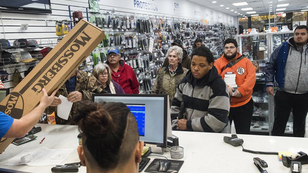 The first customers at Superior Firearms in Tyler, Texas, line up to pay for their purchases just after 7 a.m., on Black Friday, Nov. 24, 2017.