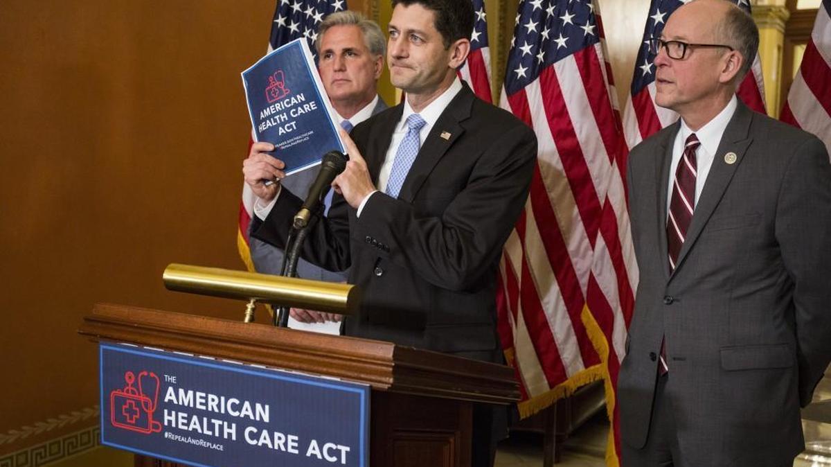 House Speaker Paul Ryan, R-Wis., holds a copy of the American Health Care Act while Rep. Greg Walden, R-Ore., right, and House Majority Leader Kevin McCarthy, R-Calif., listen during a news conference at the Capitol Building in Washington on March 7.
