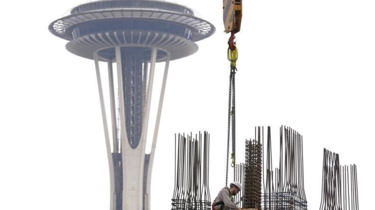 
In this photo taken Feb. 26, 2015, a construction worker puts in framing for a new high-rise building in view of the Space Needle in the South Lake Union neighborhood of Seattle. A booming real-estate market has helped boost state revenue.
