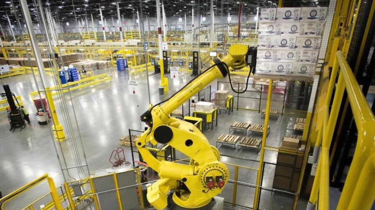 Robo-Stow moves a pallet of goods into the upper level of a 1-million-square-foot warehouse at the Amazon Fulfillment Center in Dupont on Feb. 12, 2015. The state Legislature is considering ideas to better prepare Washington residents for a workplace where robots reign.