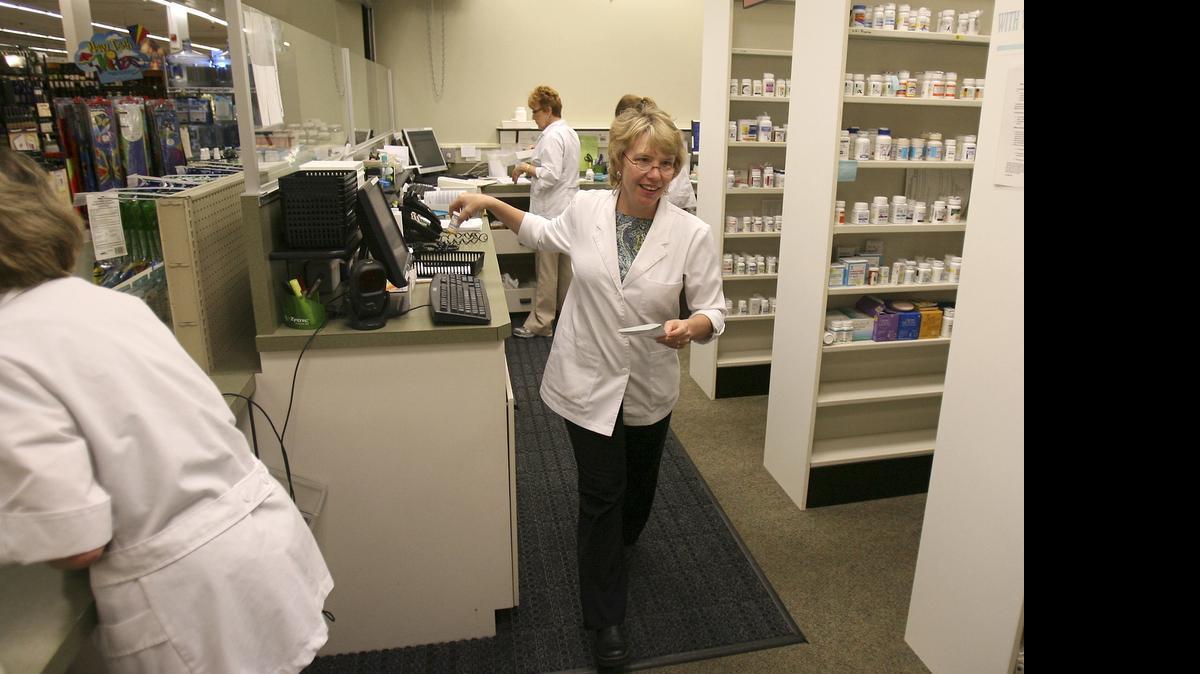 
Pharmacy manager Theresa Arneson fills a prescription in July 2007 for one of her customers at the Ralph’s Thriftway pharmacy in Olympia.
