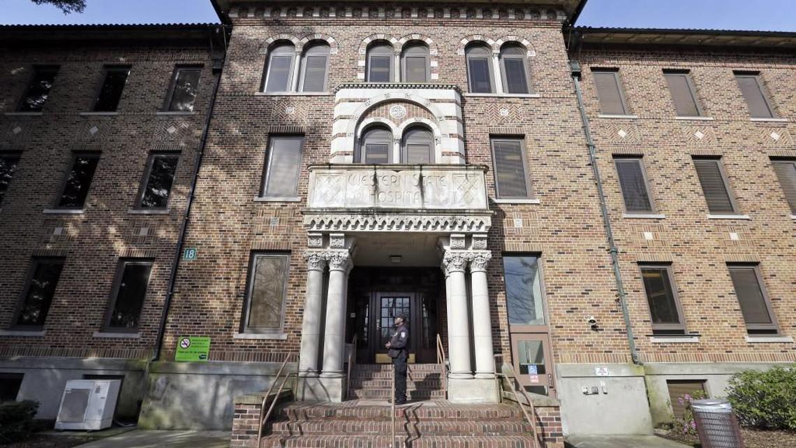 In this photo taken April 11, 2017, a security officer stands on steps at the entrance to Western State Hospital, in Lakewood. Inspectors who visited Washington state’s largest psychiatric hospital found that safety problems that thrust the facility into the national spotlight after the escape of two dangerous patients a year ago persist.