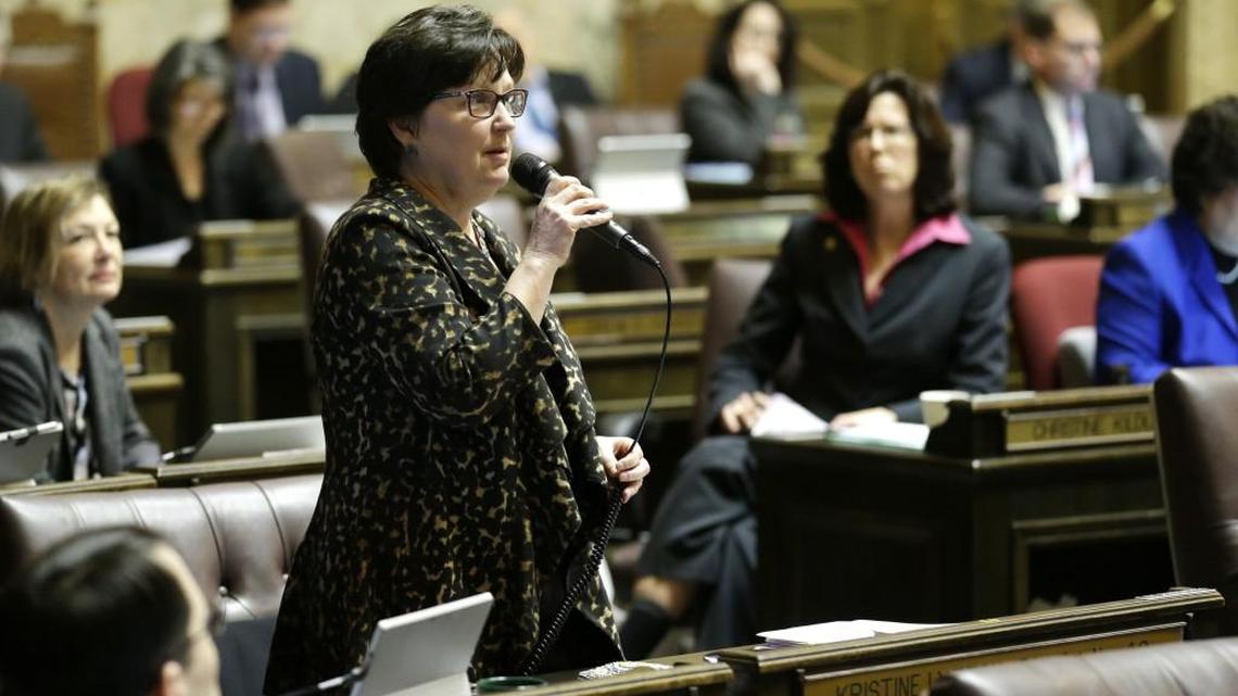 Rep. Kristine Lytton, D-Anacortes, left, speaks on the House floor Wednesday, Feb. 22, 2017, during debate over education funding at the Capitol in Olympia, Wash. The House approved its education funding proposal Wednesday, just weeks after the Republican-led Senate passed its own plan. Both sides will now need to negotiate a final compromise. Lawmakers are working to comply with a 2012 state Supreme Court ruling that they must fully fund the state's basic education system.