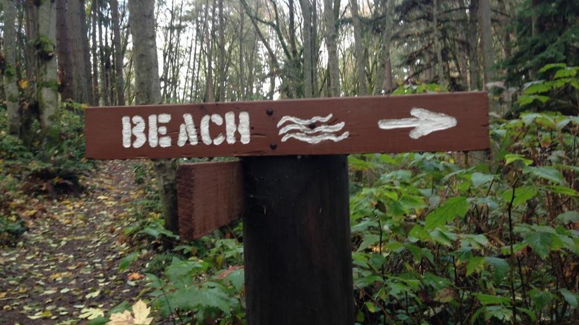 A sign points the way to Puget Sound at Dash Point State Park. A government shutdown would mean closure of parks across Washington.