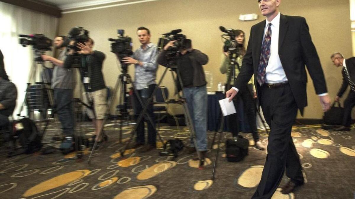 
Washington State Auditor Troy Kelley walks past a row of media before making short statement in downtown Tacoma on April 16 after being indicted in federal court earlier in the day with 10 counts of criminal activity. Federal prosecutors added eight new charges Thursday and dropped one, but the Tacoma Democrat still faces up to 20 years in prison if convicted.
