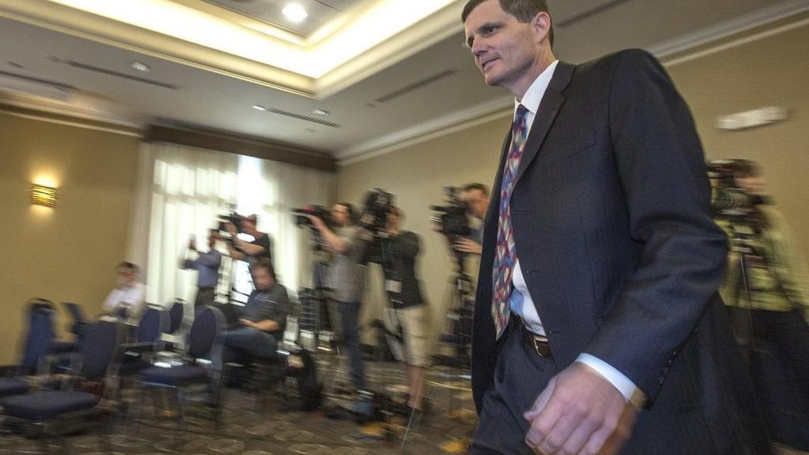
Washington State Auditor Troy Kelley walks past a row of reporters and photographers in April at a downtown Tacoma hotel shortly after he was indicted in federal court earlier in the day.
