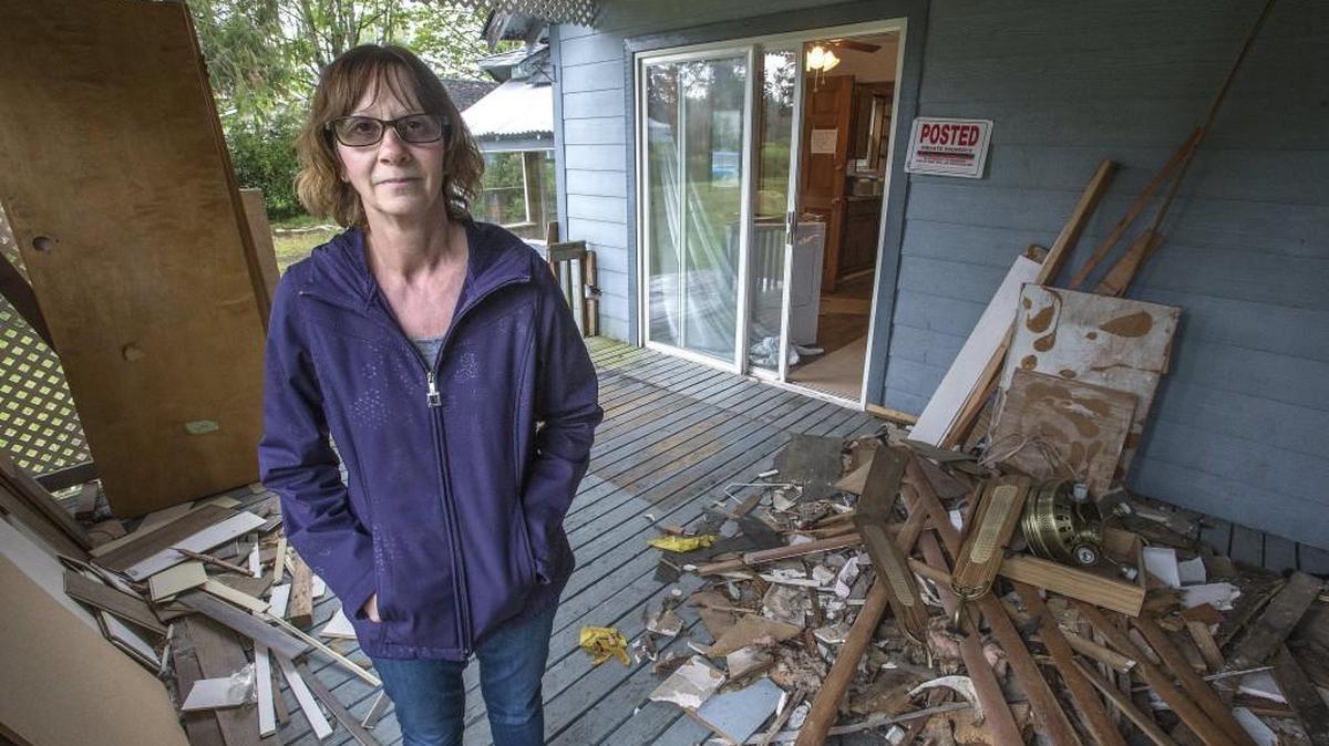 Rose Nelson stands on the porch of the Parkland-area rental home she said squatters used over six weeks in 2015 and 2016, causing $21,000 dollars in damage. Nelson said she was told by Pierce County Sheriff’s deputies that they couldn’t evict the squatters because it was a civil matter. A bill signed into law Wednesday aims to make it easier for property owners to evict squatters.