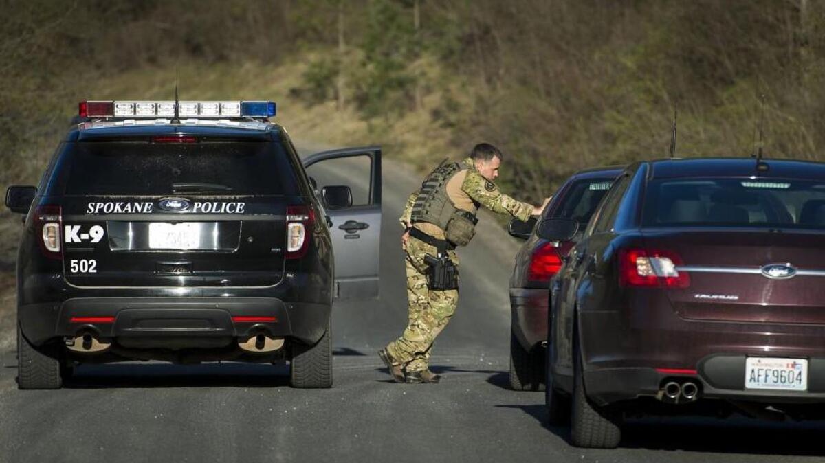Officials stop vehicles as they search in Spokane Valley in April for escaped mental patient Anthony Garver.