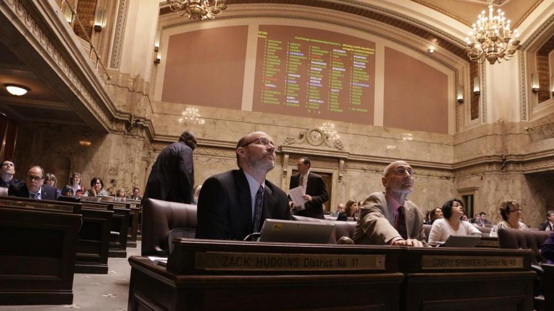 Lawmakers in the House watch the vote board during one of 27 votes to override gubernatorial vetoes, Tuesday, March 29, 2016, in Olympia, Wash. The last time the Legislature overrode a veto was in 1998.