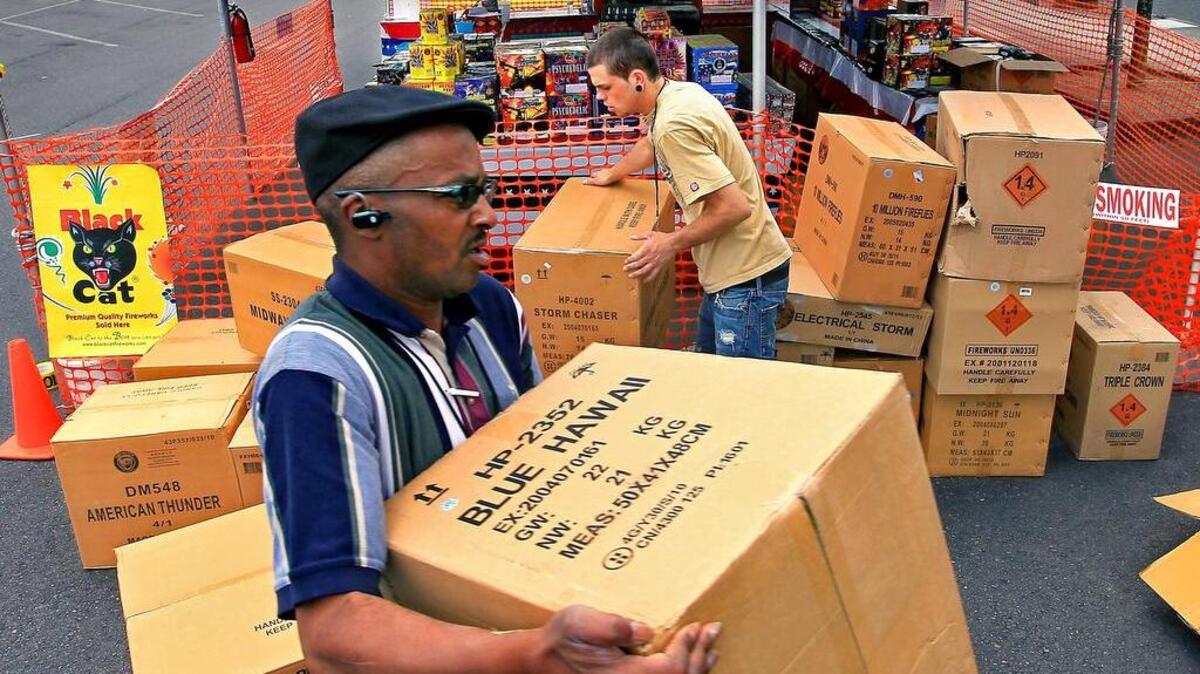 
Victor Nelson, of Bonney Lake, left, and Tanner Rogers of Milton unload and display fireworks at a Hale fireworks stand in Puyallup in June 2011.
